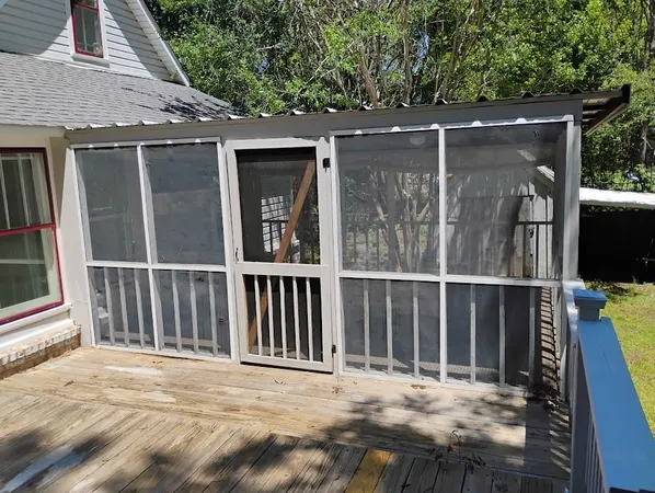 a backyard of a house with a table and chairs