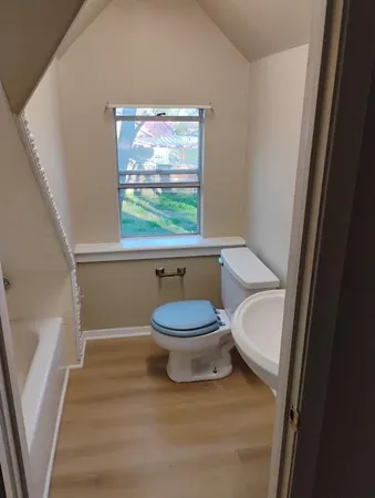 a white toilet sitting next to a bathroom sink