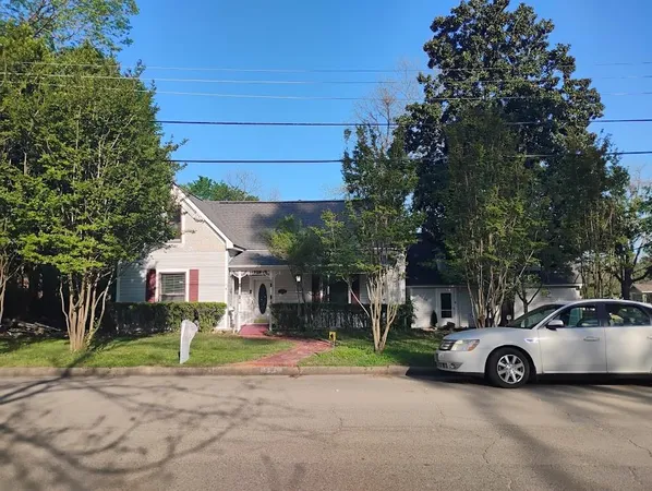 a view of a car parked in front of a house