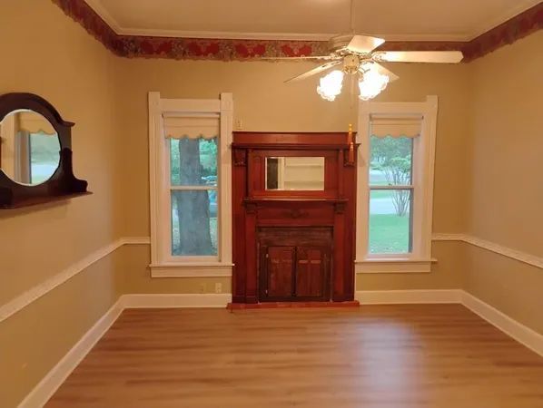 a view of a livingroom with a fireplace and wooden floor