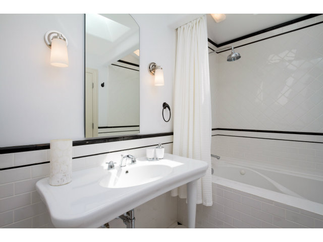 1021 Ocean Road Pebble Beach, CA 93953 - Photo 15 of 25 a bathroom with a sink and a mirror