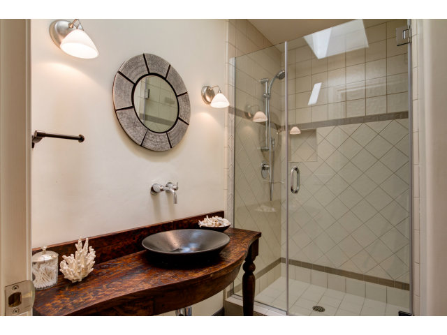 1021 Ocean Road Pebble Beach, CA 93953 - Photo 17 of 25 a bathroom with a sink and a mirror