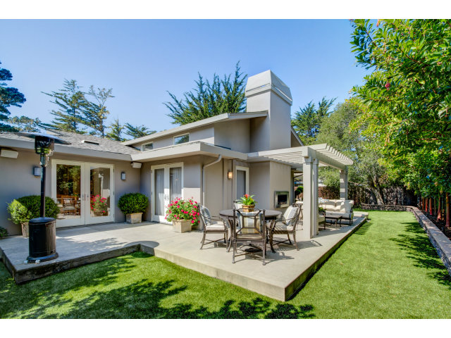 1021 Ocean Road Pebble Beach, CA 93953 - Photo 19 of 25 a view of a house with patio and a yard