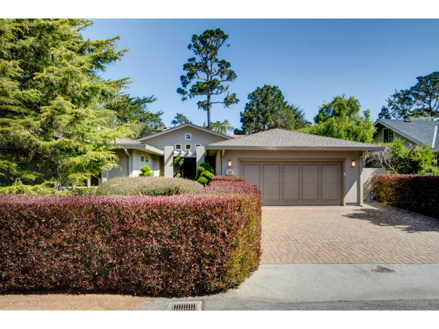 1021 Ocean Road Pebble Beach, CA 93953 - Photo 25 of 25 a front view of a house with a yard and garage