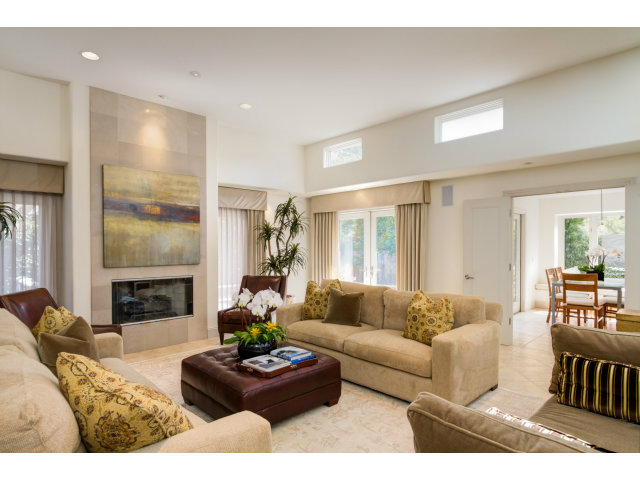 1021 Ocean Road Pebble Beach, CA 93953 - Photo 4 of 25 a living room with furniture a fireplace and a dining table with wooden floor
