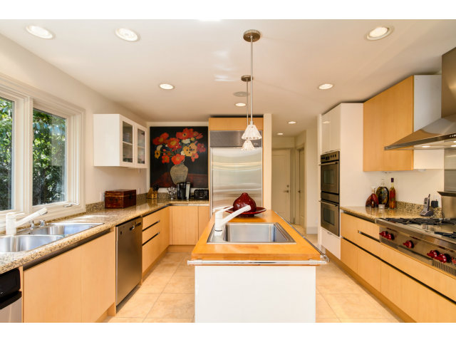 1021 Ocean Road Pebble Beach, CA 93953 - Photo 7 of 25 a kitchen with stainless steel appliances kitchen island sink stove and cabinets