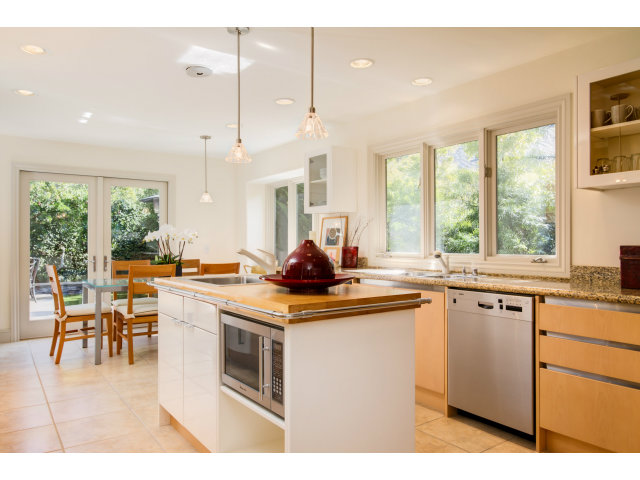 1021 Ocean Road Pebble Beach, CA 93953 - Photo 8 of 25 a kitchen with stainless steel appliances granite countertop a stove a sink a dining table and chairs