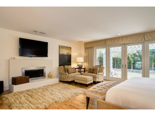 1021 Ocean Road Pebble Beach, CA 93953 - Photo 9 of 25 a bedroom with a large bed and a flat screen tv