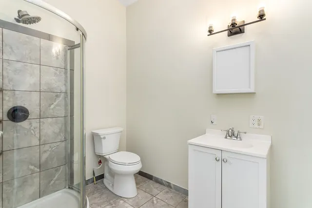 a bathroom with a toilet sink and shower