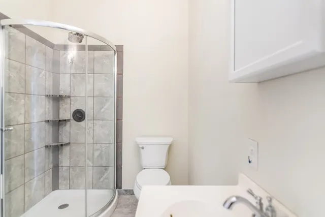 a bathroom with a toilet and shower