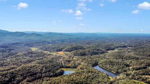 a view of a dry yard with mountains in the background
