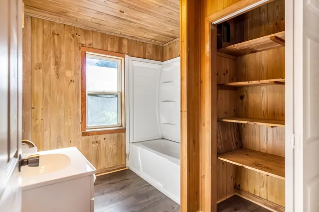a bathroom with a tub and shower