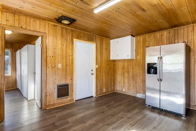 a view of a refrigerator in kitchen and wooden floor