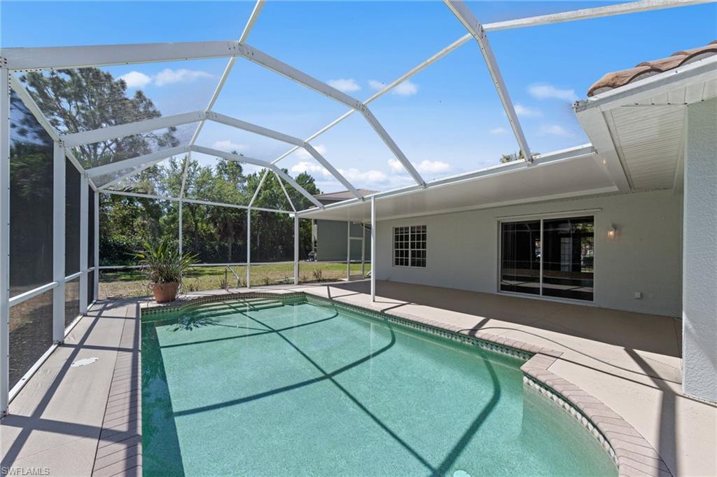 9623 Springlake Circle Estero, FL 33928 - Photo 42 of 47 a swimming pool with outdoor seating and yard