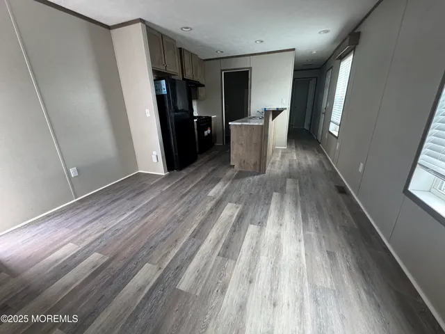 a view of a room with wooden floor and staircase