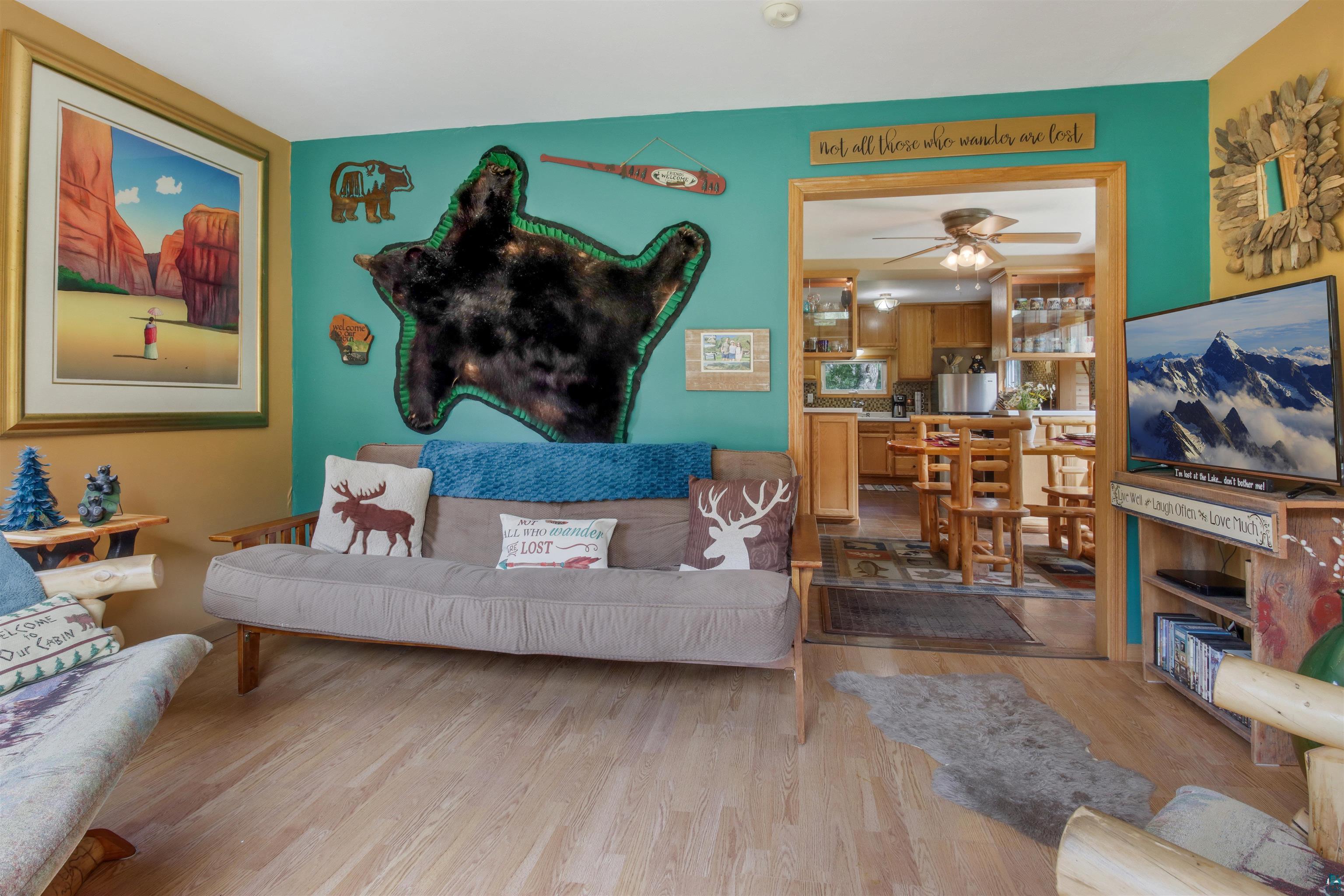 N8348 Island Lake Road Spooner, WI 54801 - Photo 11 of 40 Living room featuring ceiling fan and wood-type flooring