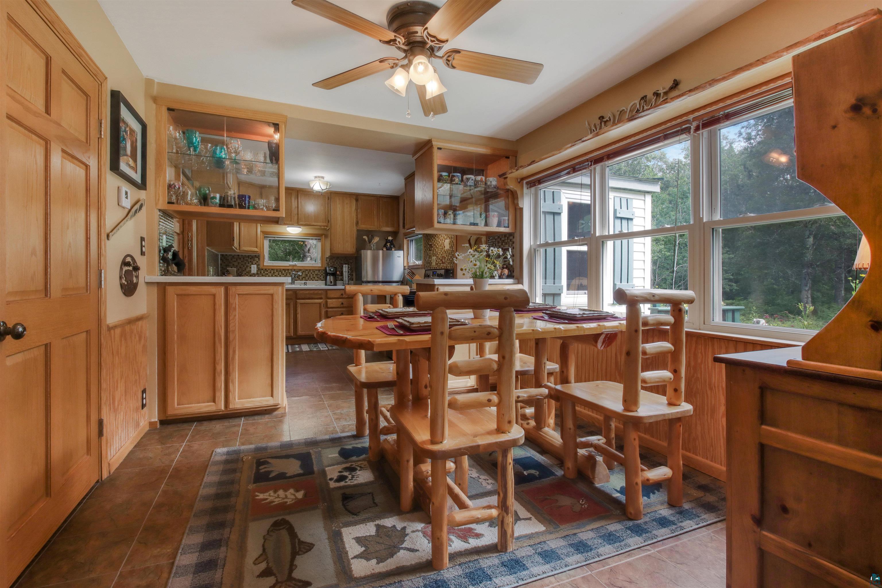 N8348 Island Lake Road Spooner, WI 54801 - Photo 13 of 40 Dining space with tile patterned flooring and ceiling fan