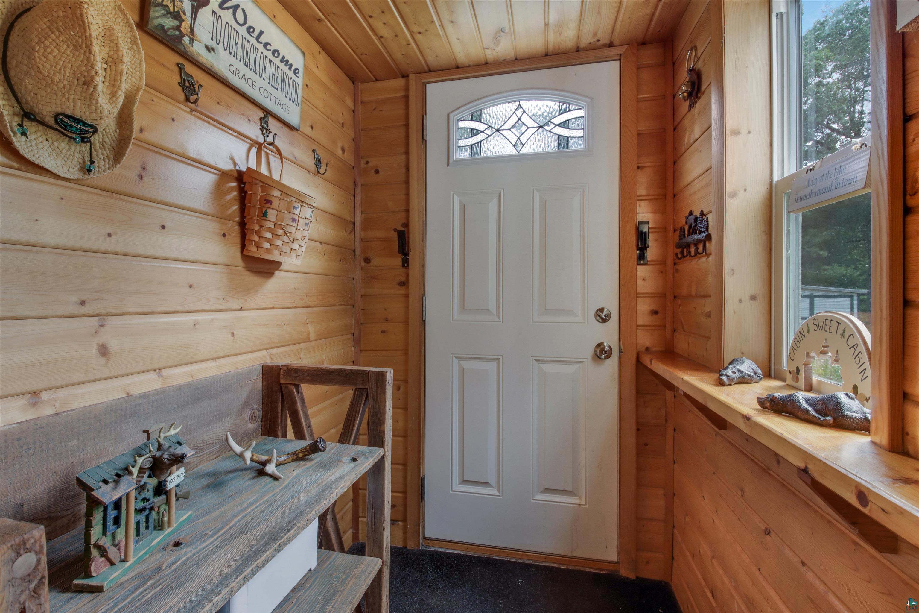 N8348 Island Lake Road Spooner, WI 54801 - Photo 23 of 40 Doorway to outside featuring wood walls and wooden ceiling