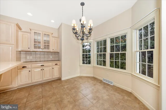a kitchen with a refrigerator a sink and cabinets