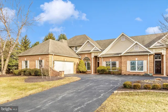 a living room with stainless steel appliances cabinets and a wooden floor