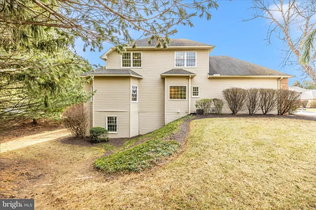 a spacious bathroom with a tub sink and mirror