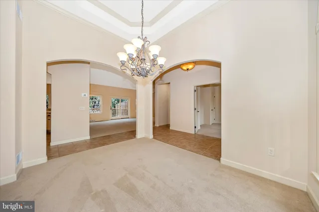 a view of an empty room with a fireplace and a window