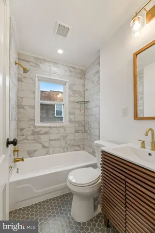 a bathroom with a toilet a sink and bathtub