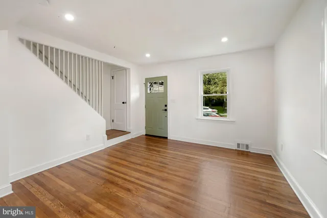 wooden floor in an empty room with a window
