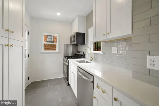 a kitchen with a sink stove and cabinets