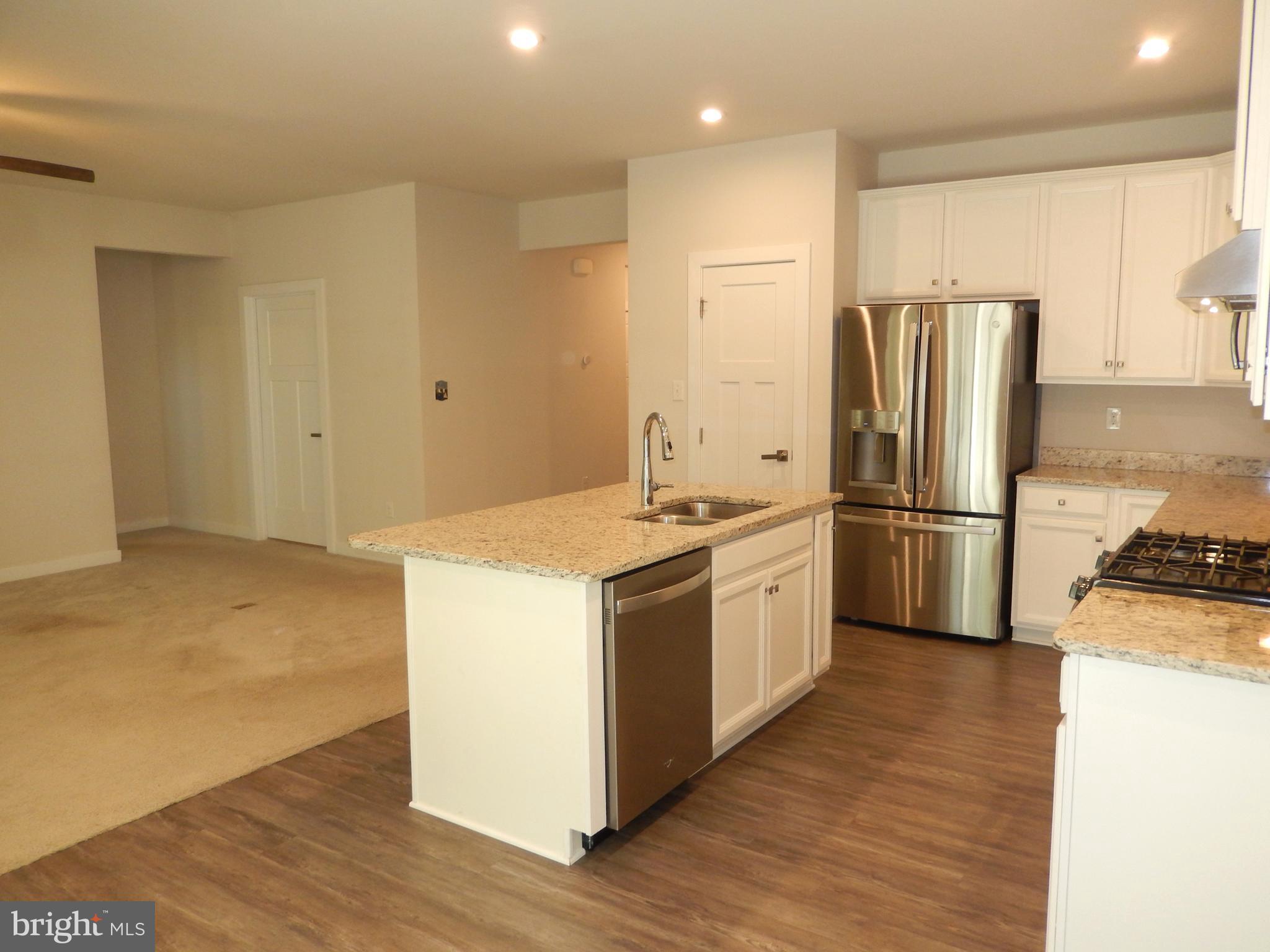 36884 Red Cedar Loop Ocean View, DE 19970 - Photo 15 of 50 a kitchen with a refrigerator sink and wooden floor