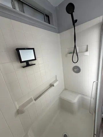 a bathroom with a toilet and a shower