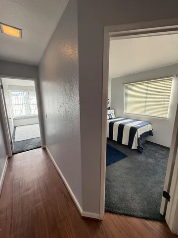a view of a livingroom with wooden floor and window
