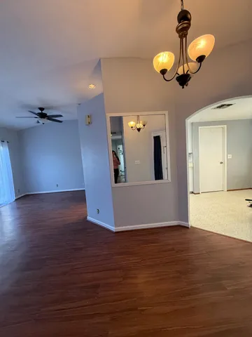 a view of a room with wooden floor