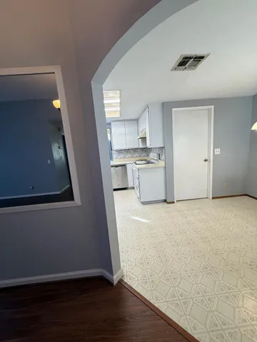 a view of a kitchen with wooden floor and a sink