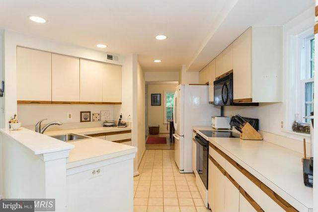 1500 Deer Point Way Reston, VA 20194 - Photo 11 of 26 a kitchen with a sink a stove and cabinets