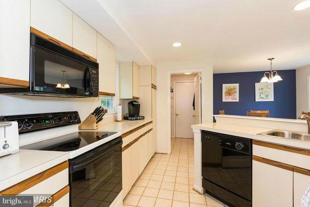 1500 Deer Point Way Reston, VA 20194 - Photo 12 of 26 a kitchen with a sink stove and microwave