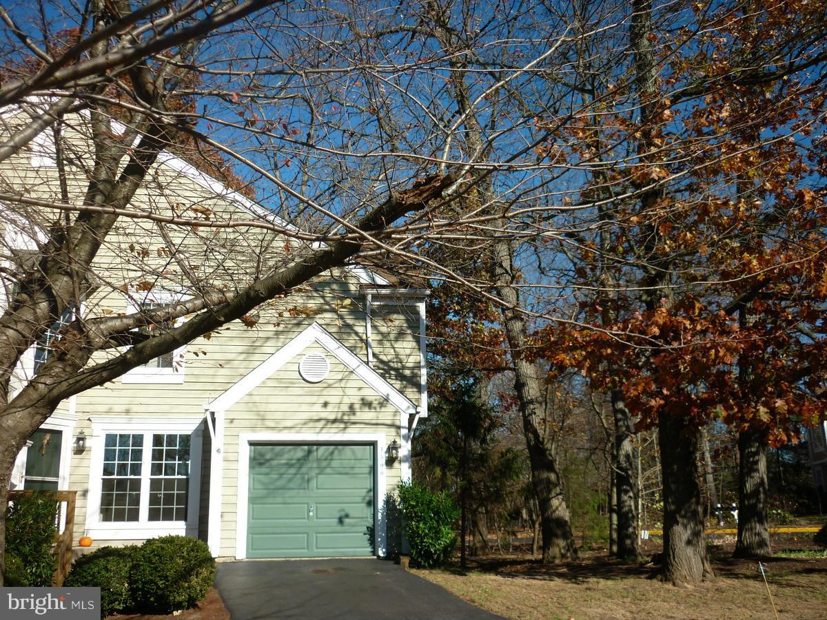 1500 Deer Point Way Reston, VA 20194 - Photo 3 of 26 a view of a white house with a large tree