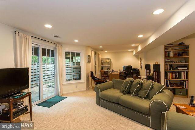 1500 Deer Point Way Reston, VA 20194 - Photo 21 of 26 a living room with furniture a flat screen tv and a refrigerator