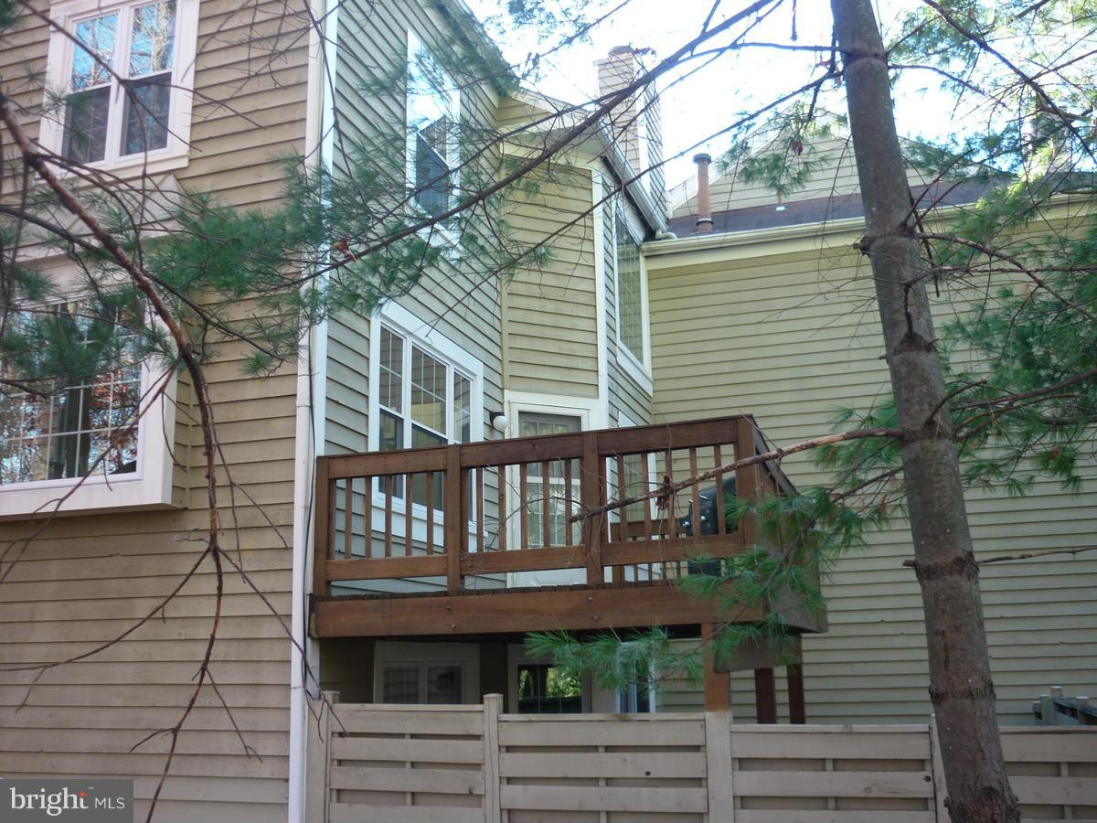 1500 Deer Point Way Reston, VA 20194 - Photo 23 of 26 a view of a brick house with a small yard