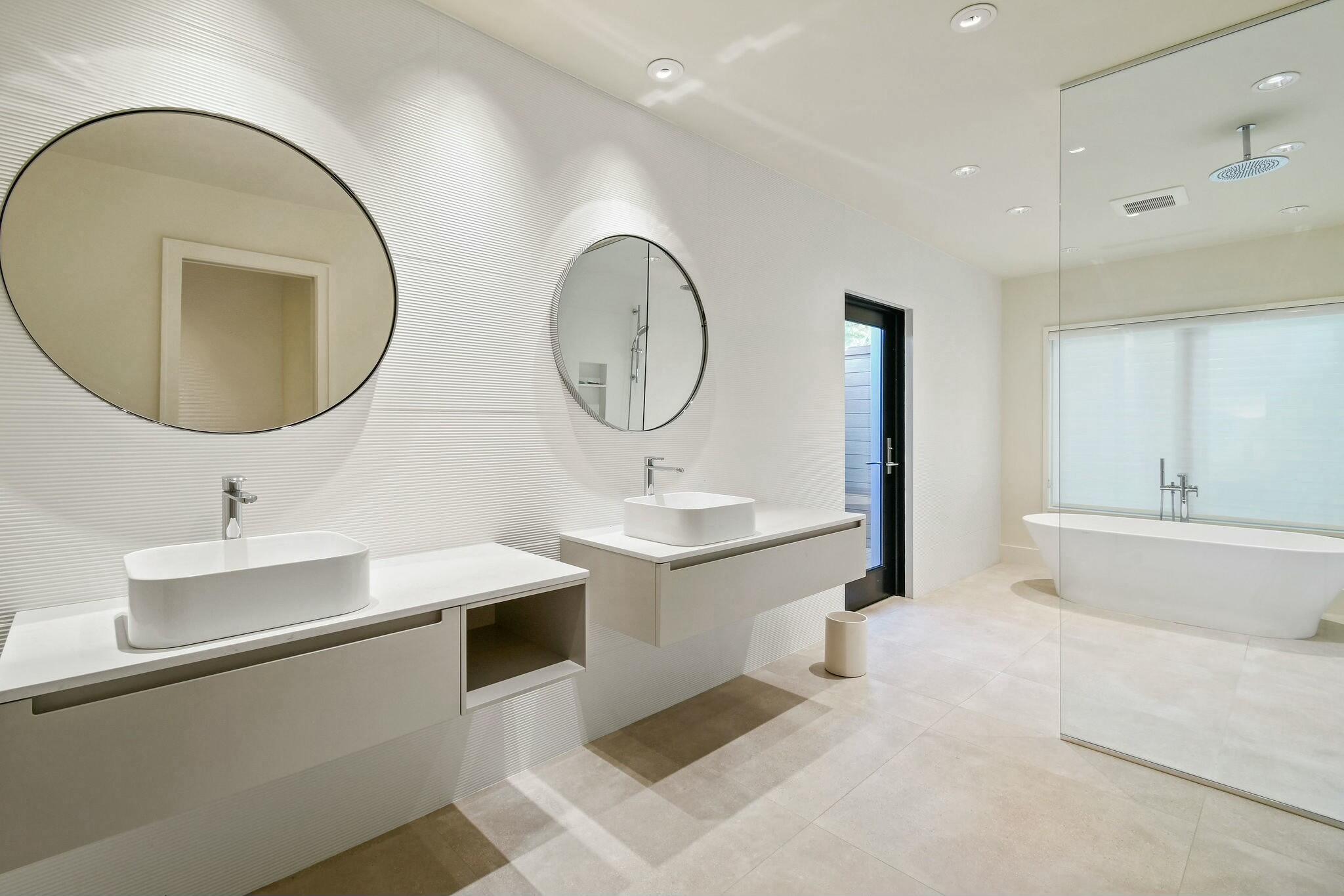 170 Beacon Lane Jupiter Inlet Colony, FL 33469 - Photo 15 of 46 a bathroom with a double vanity sink mirror and bathtub