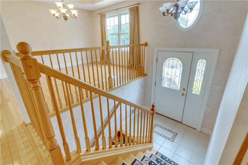 452 Sharon Road Coraopolis, PA 15108 - Photo 2 of 23 The inviting foyer offers tile flooring and a split hardwood staircase.