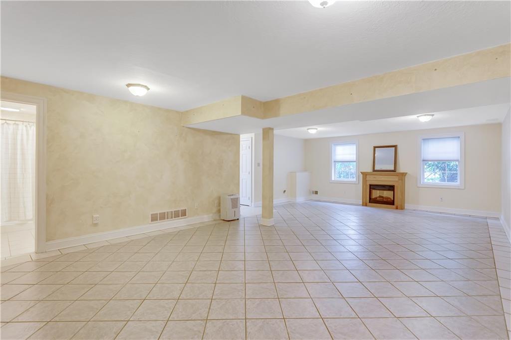 452 Sharon Road Coraopolis, PA 15108 - Photo 17 of 23 The finished lower level offers tile flooring and an electric fireplace.