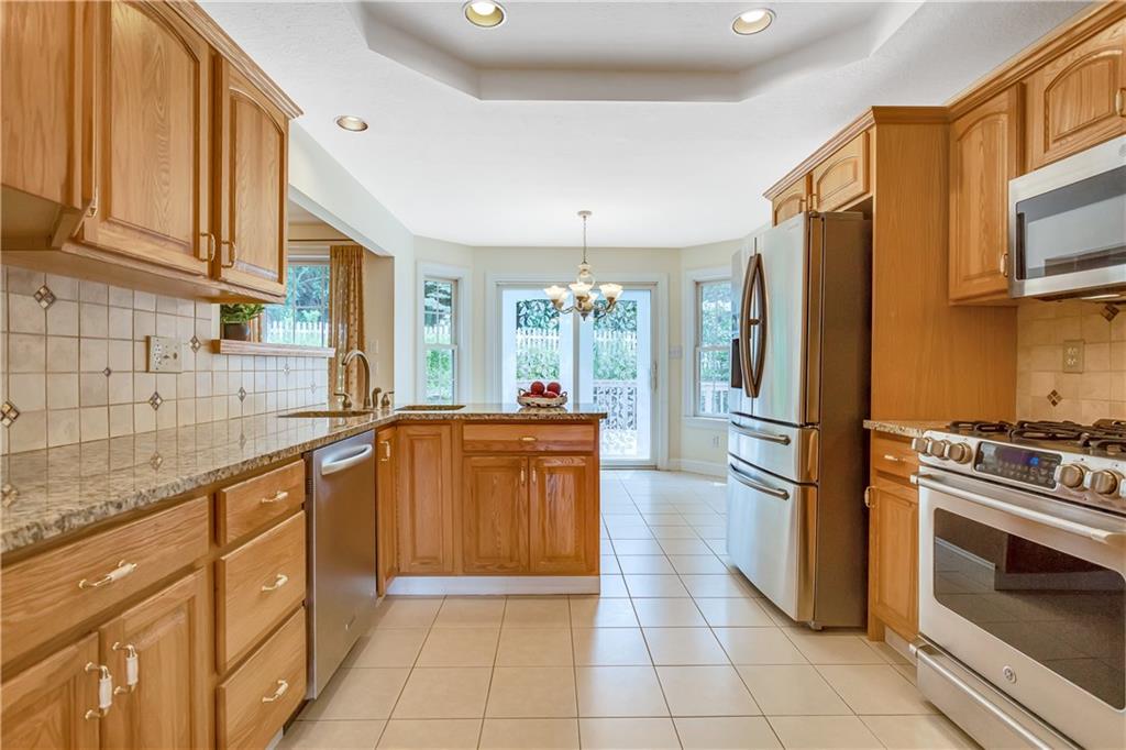 452 Sharon Road Coraopolis, PA 15108 - Photo 6 of 23 The beautiful kitchen offers granite counter tops accented with a tile back splash, upgraded stainless appliances, a Trey ceiling and tile flooring.
