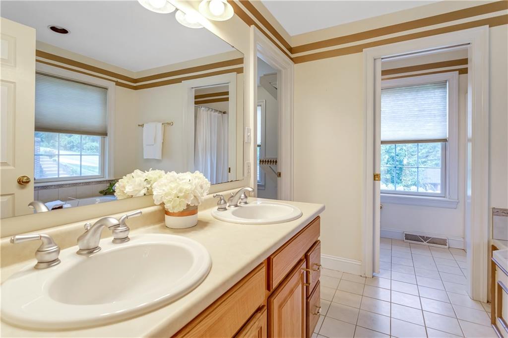 452 Sharon Road Coraopolis, PA 15108 - Photo 10 of 23 The master bath includes a double sink vanity and tiled floors.