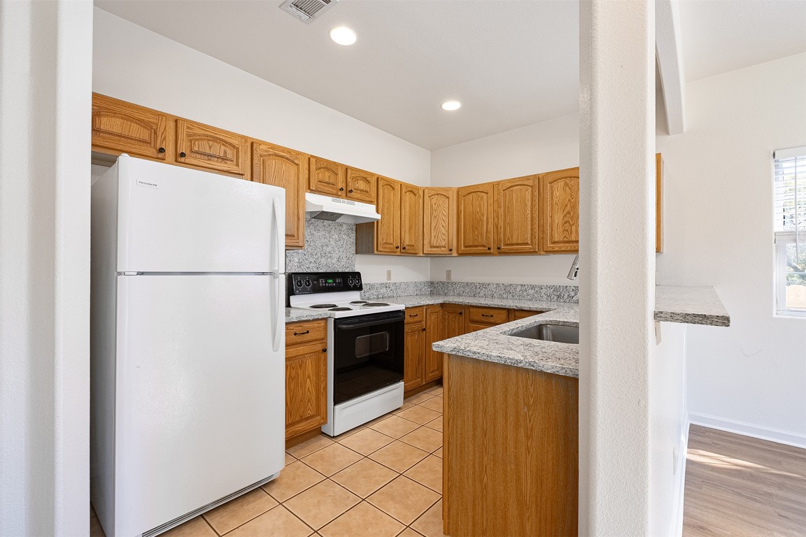 1003 Canyon Edge Drive, Unit B Austin, TX 78733 - Photo 12 of 25 a kitchen with a refrigerator sink and stove