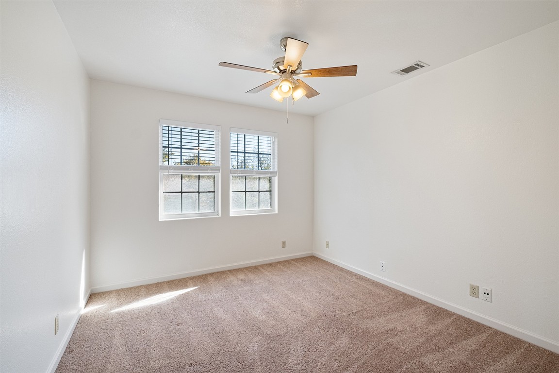 1003 Canyon Edge Drive, Unit B Austin, TX 78733 - Photo 17 of 25 an empty room with a window and a fan