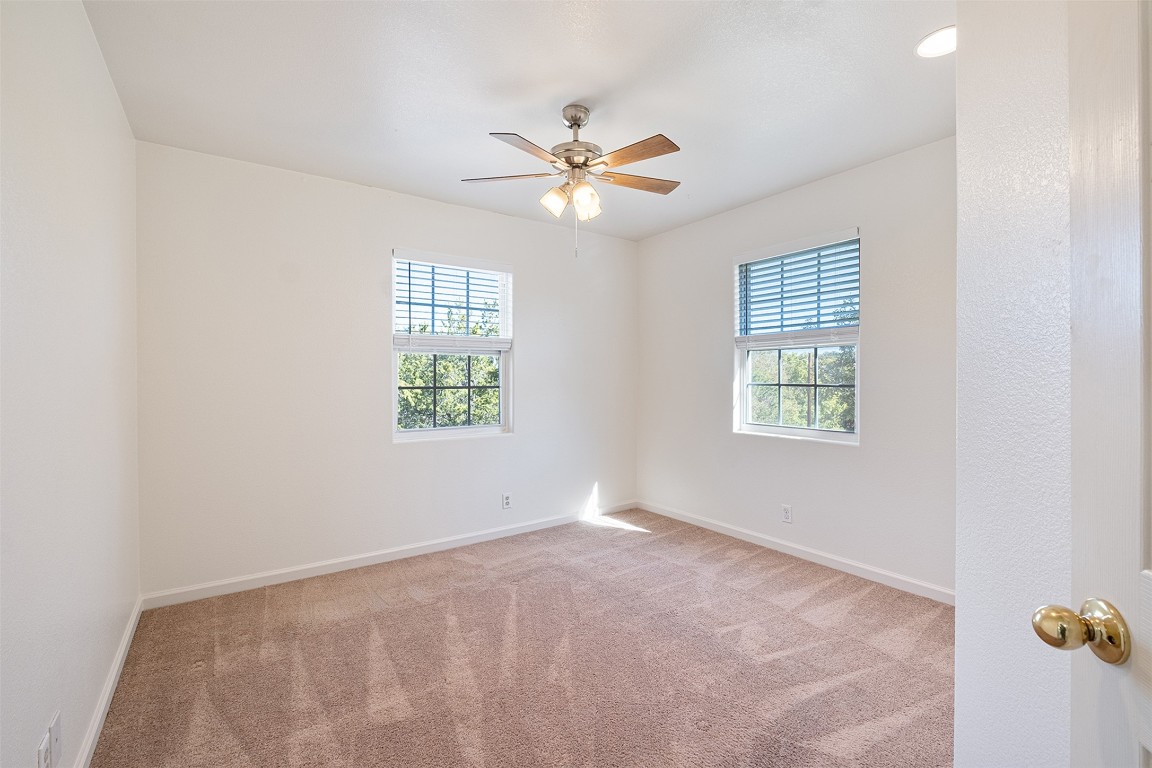1003 Canyon Edge Drive, Unit B Austin, TX 78733 - Photo 20 of 25 an empty room with windows and fan