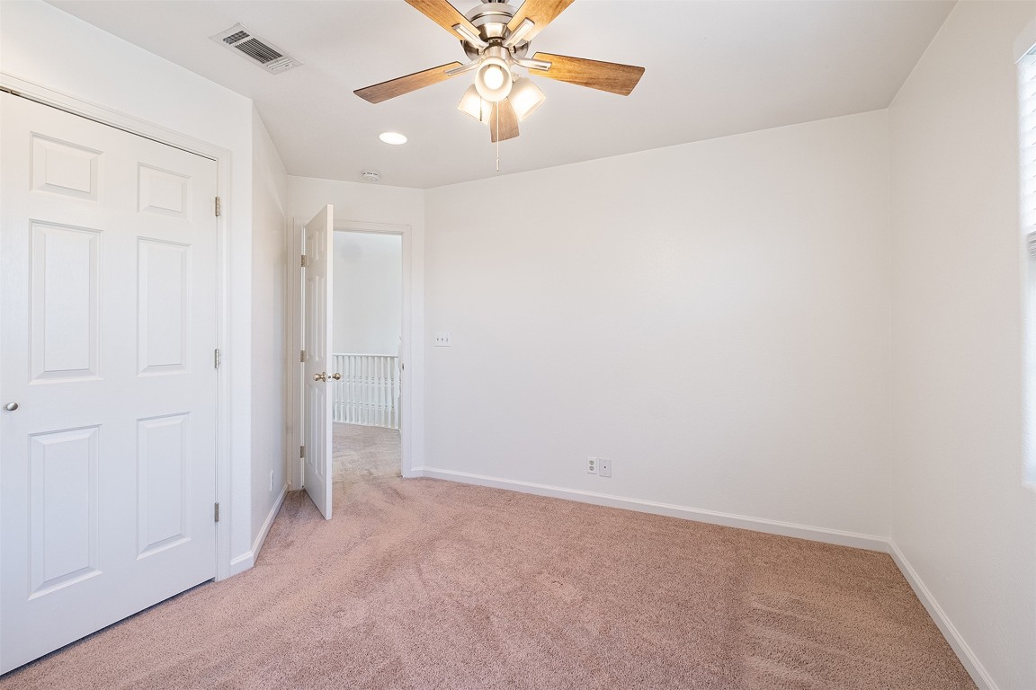 1003 Canyon Edge Drive, Unit B Austin, TX 78733 - Photo 21 of 25 an empty room with closet and a chandelier fan