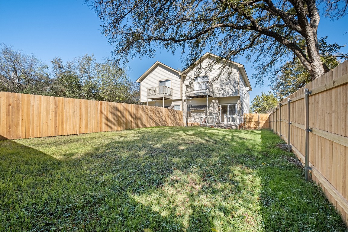 1003 Canyon Edge Drive, Unit B Austin, TX 78733 - Photo 24 of 25 a front view of a house with garden