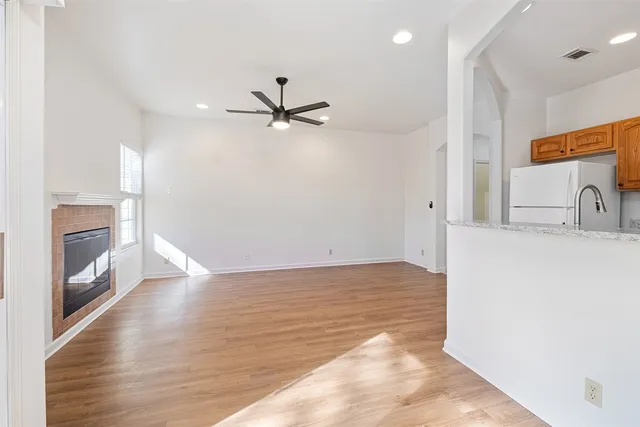a view of a kitchen with a sink and a ceiling fan